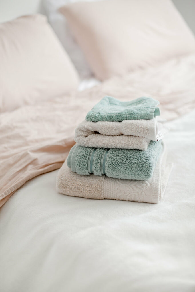 Neatly Folded Towels Placed On A Bed 682x1024